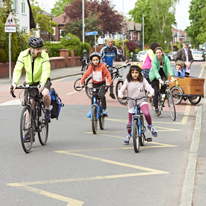 People riding bikes on road
