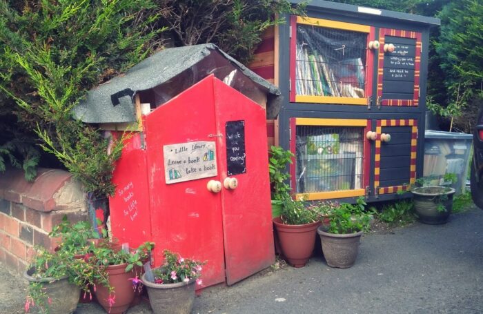 Photograph showing the covered hutches full of books at the free little library on Lowther Road in Prestwich.