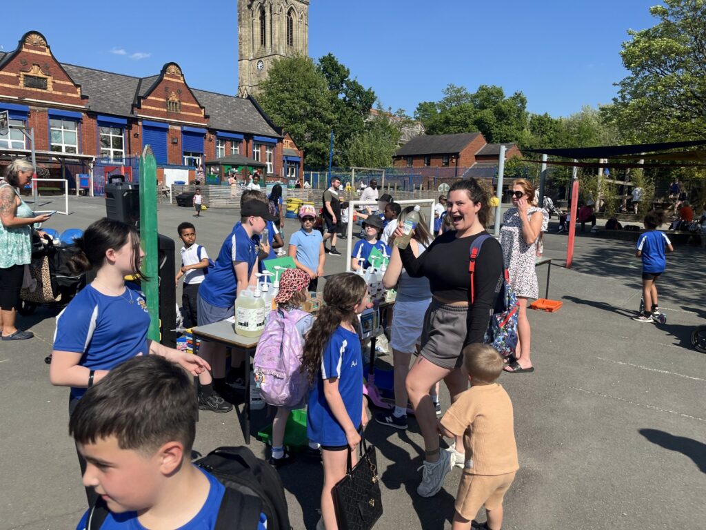 Chidlren at St Peter's Primary Rochdale with shop in playground