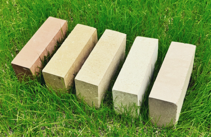 Five bricks on grass